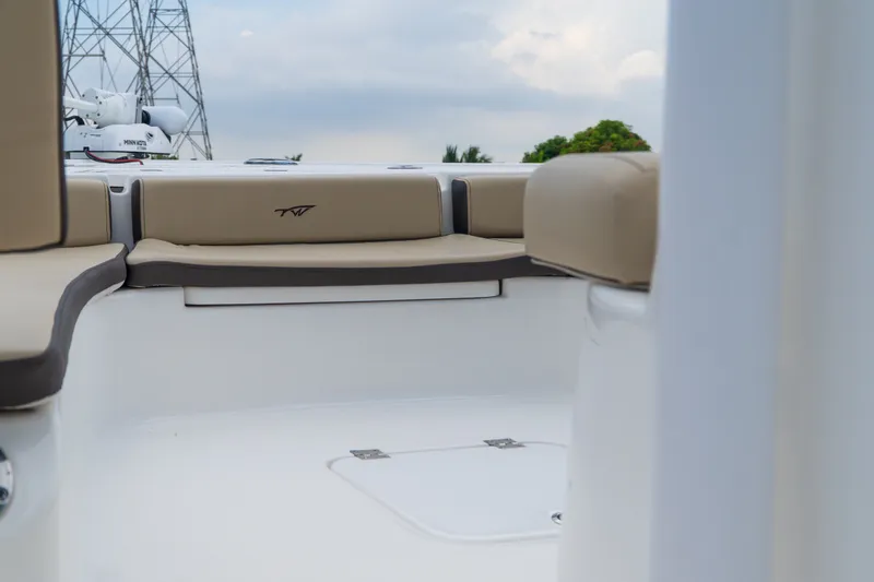 Slide: The Image of 2021 Tidewater 2300 Carolina Bay boat interior with beige seating and sleek design. - 17