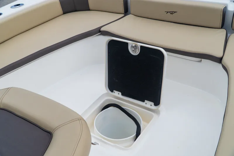 Slide: The Image of 2021 Tidewater 2300 Carolina Bay boat interior with storage compartment and seating. - 23