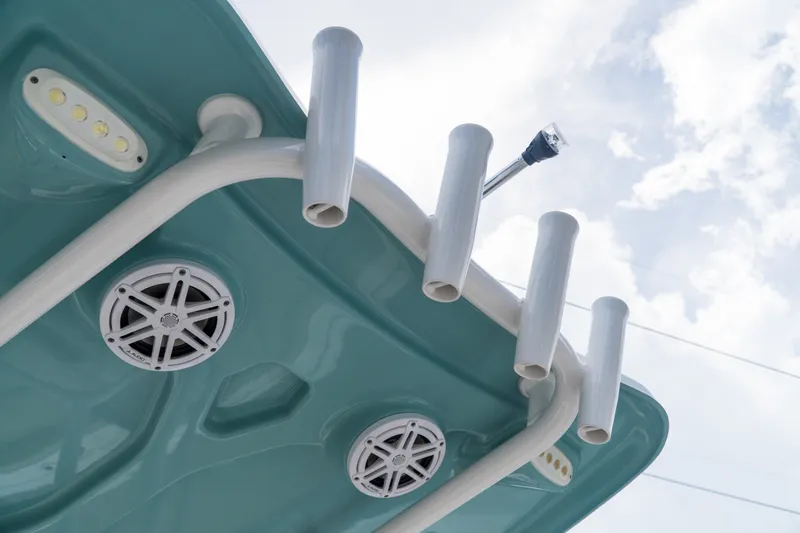 Slide: The Image of Tidewater 2300 Carolina Bay 2021 boat with rod holders and speakers under a blue sky. - 38