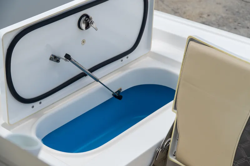 Slide: The Image of 2021 Tidewater 2300 Carolina Bay boat storage compartment with open lid and cushioned seat. - 41