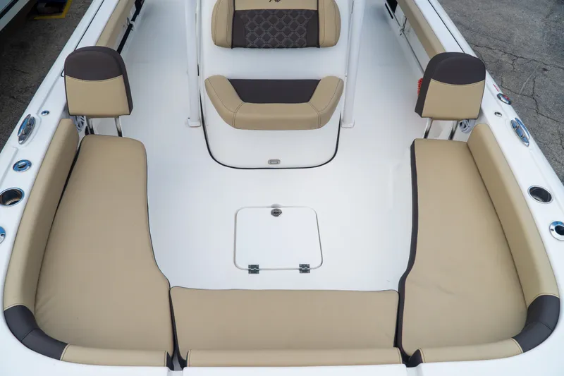 Slide: The Image of 2021 Tidewater 2300 Carolina Bay boat interior with beige seating and storage compartments. - 25