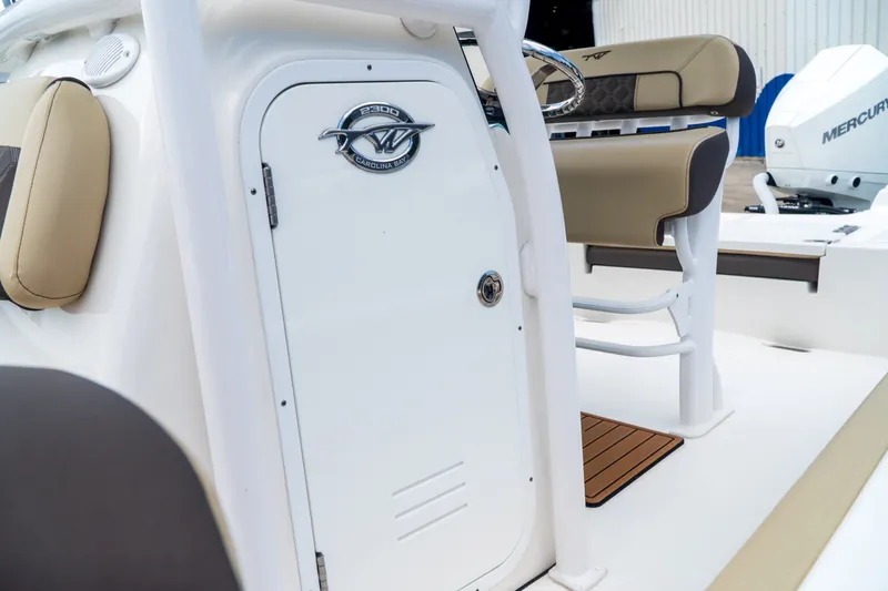 Slide: The Image of 2021 Tidewater 2300 Carolina Bay boat interior with seating and storage compartment. - 30