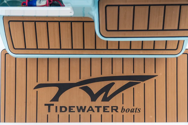 Slide: The Image of Tidewater 2300 Carolina Bay 2021 boat deck with logo and wood finish. - 35