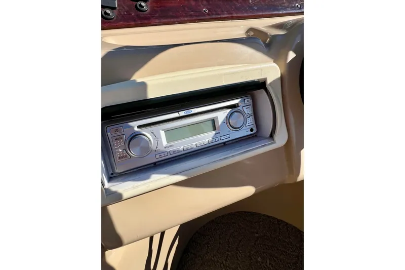 Slide: The Image of 2013 South Bay 417 CR boat stereo system in beige dashboard. - 21
