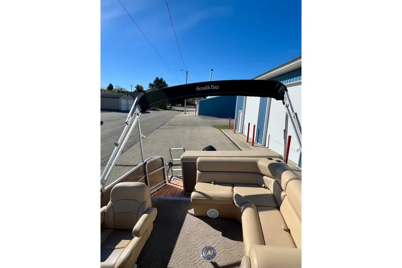 Slide: The Image of 2013 South Bay 417 CR pontoon boat with beige seating and black canopy. - 49