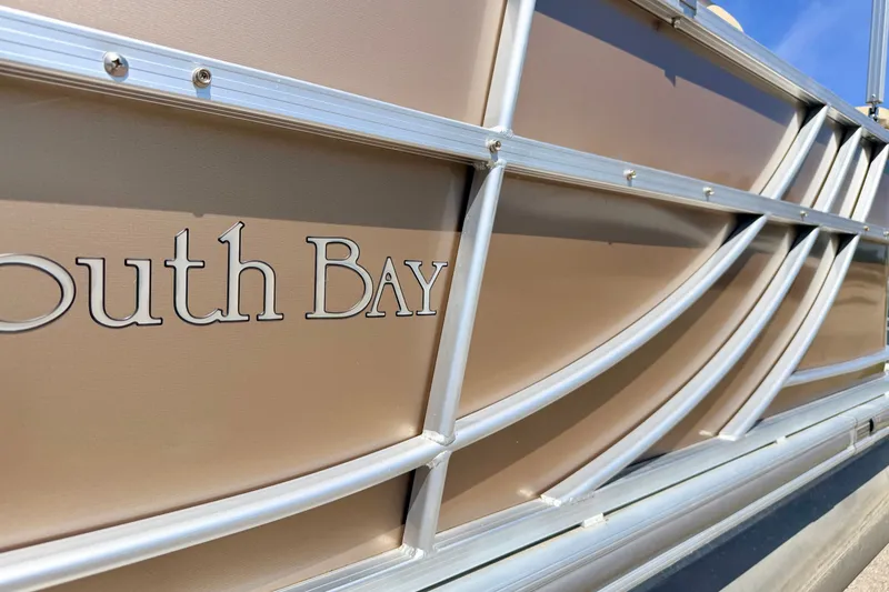 Slide: The Image of Close-up of 2013 South Bay 417 CR boat exterior with logo and metal framework. - 21