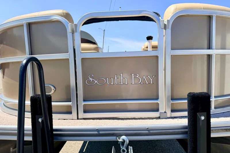 Slide: The Image of 2013 South Bay 417 CR pontoon boat, rear view with logo, sunny day. - 8
