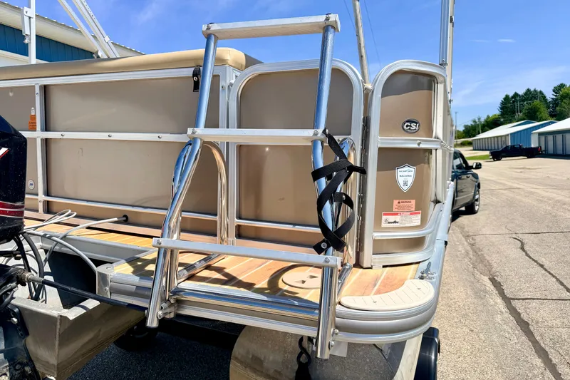 Slide: The Image of 2013 South Bay 417 CR pontoon boat with ladder and motor, parked outdoors. - 18