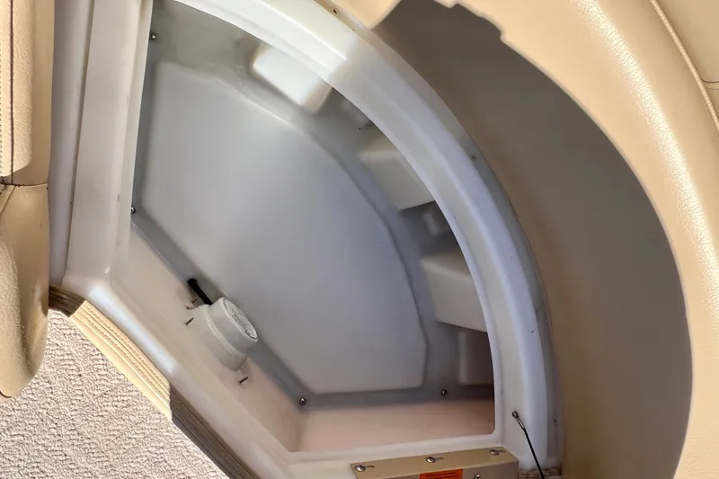 Slide: The Image of Storage compartment in a 2013 South Bay 417 CR boat, featuring beige interior. - 16