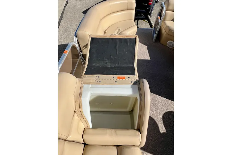 Slide: The Image of Open storage compartment on 2013 South Bay 417 CR boat with beige seating. - 27