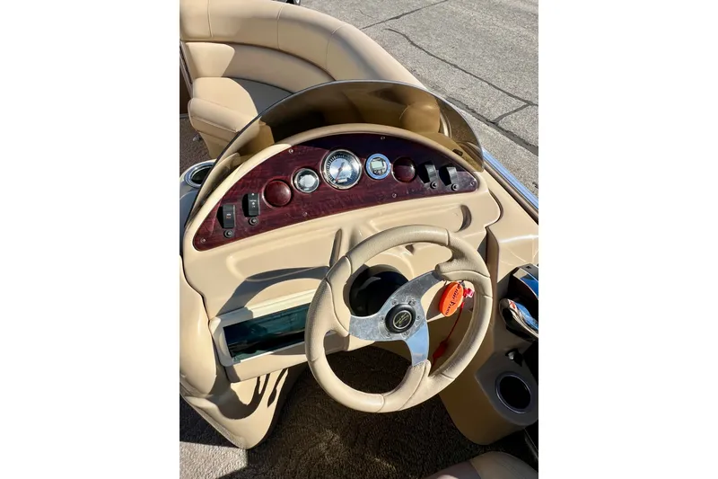Slide: The Image of 2013 South Bay 417 CR boat dashboard with steering wheel and gauges. - 19