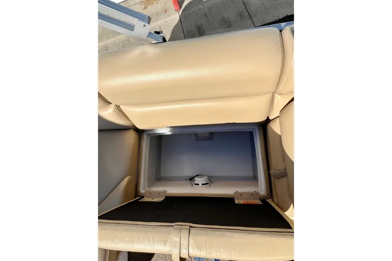 Slide: The Image of Storage compartment in beige seating of 2013 South Bay 417 CR boat. - 26