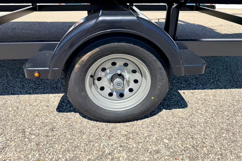 Slide: The Image of Trailer wheel of a 2013 South Bay 417 CR on asphalt surface. - 74