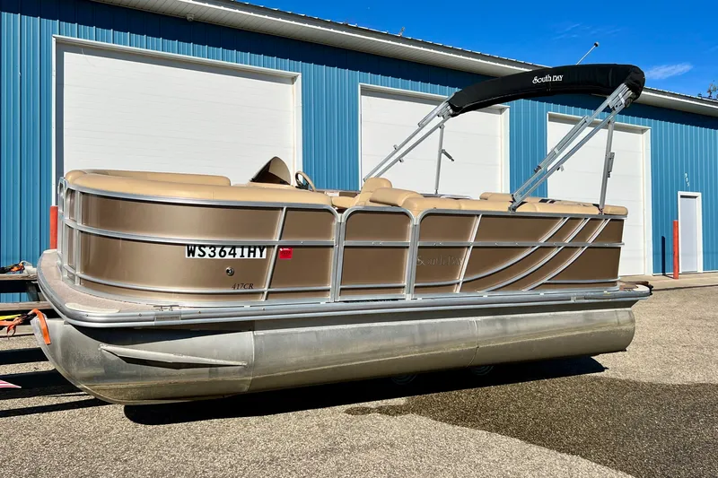 The Image of 2013 South Bay 417 CR pontoon boat parked outside blue warehouse. - 0