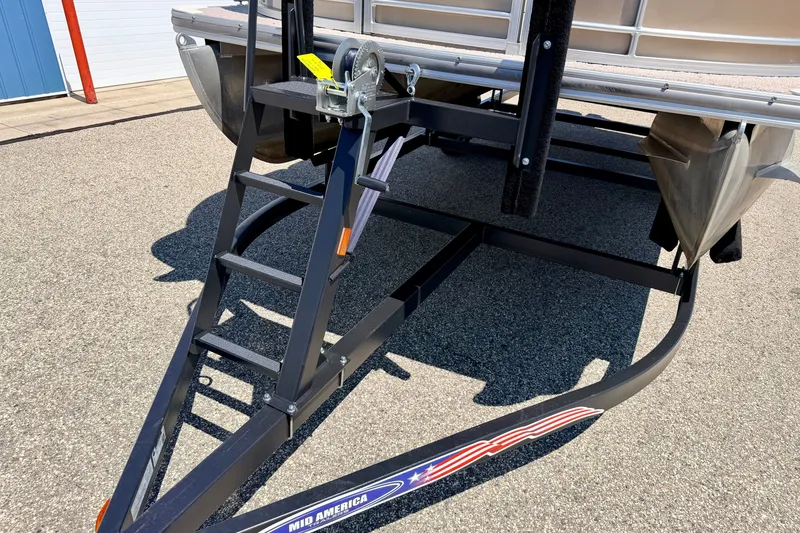 Slide: The Image of Trailer hitch and ladder of a 2013 South Bay 417 CR boat on pavement. - 73
