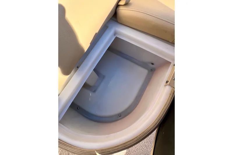 Slide: The Image of Storage compartment in 2013 South Bay 417 CR boat, featuring beige upholstery. - 15