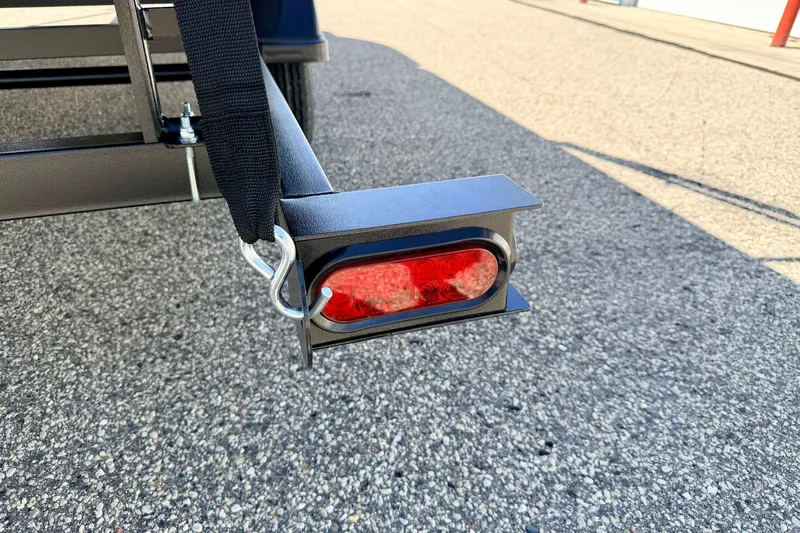 Slide: The Image of Close-up of a 2013 South Bay 417 CR trailer light and hitch on asphalt. - 77