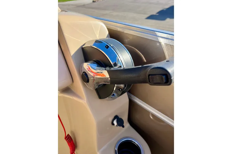 Slide: The Image of Steering wheel of 2013 South Bay 417 CR boat, featuring chrome and black accents. - 45