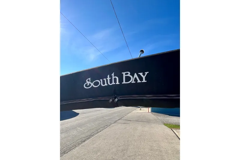 Slide: The Image of Black canopy with "South Bay" logo under clear blue sky. - 50