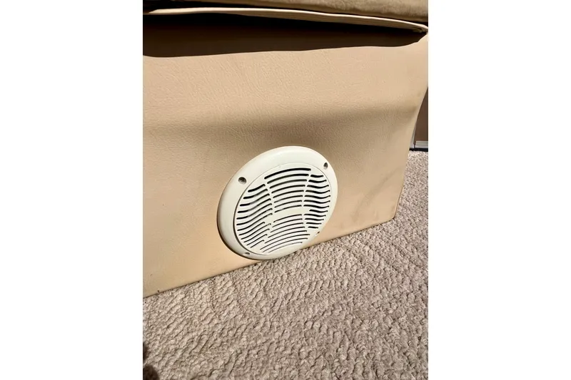 Slide: The Image of Speaker on beige upholstery in 2013 South Bay 417 CR boat interior. - 14