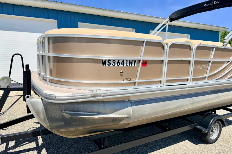 Slide: The Image of 2013 South Bay 417 CR pontoon boat on trailer, beige exterior, parked outdoors. - 9