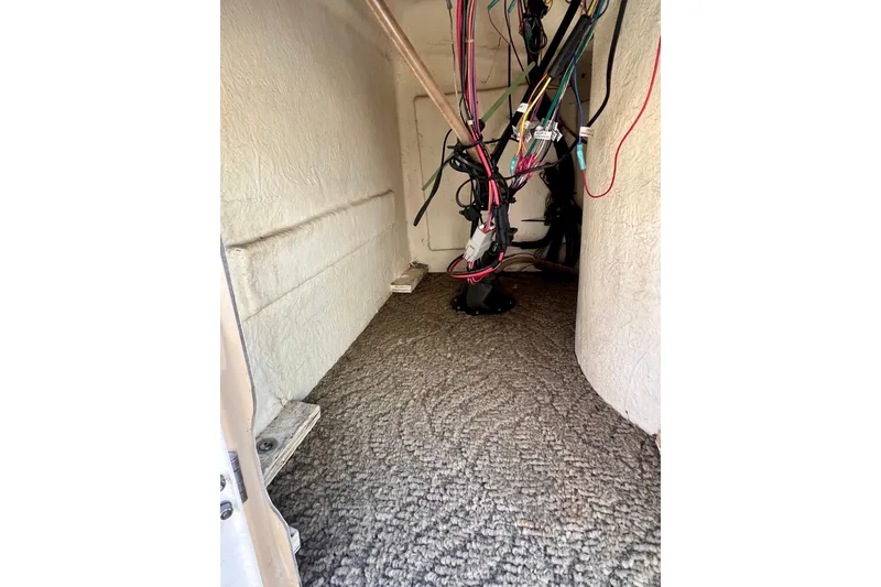 Slide: The Image of Interior wiring of a 2013 South Bay 417 CR boat, showing cables and carpeted flooring. - 17