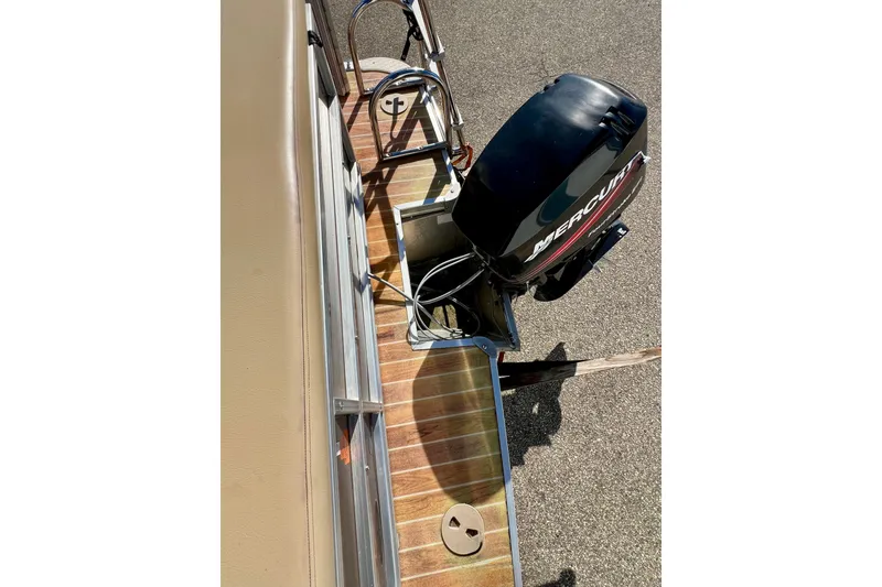 Slide: The Image of 2013 South Bay 417 CR boat with Mercury outboard motor on wooden deck. - 33