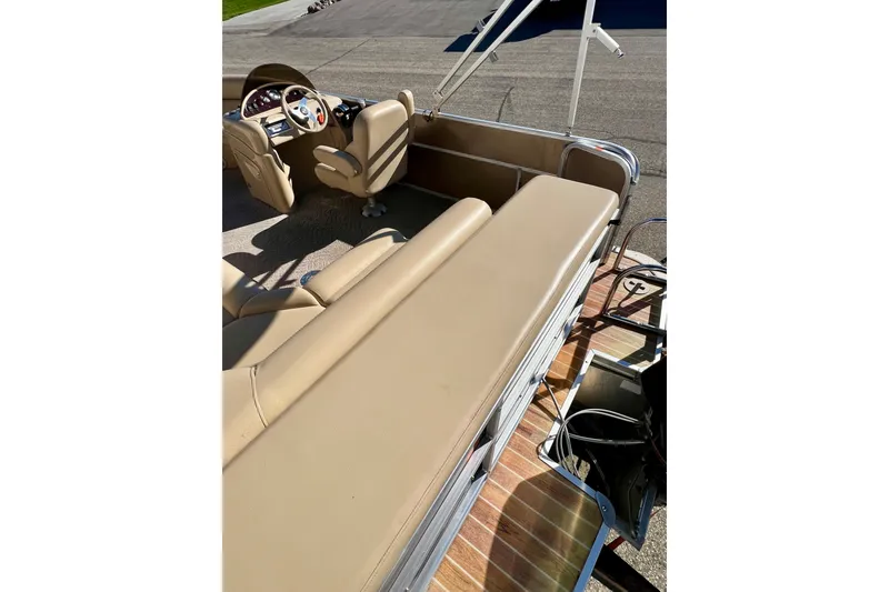 Slide: The Image of 2013 South Bay 417 CR boat interior with beige seating and steering console. - 37