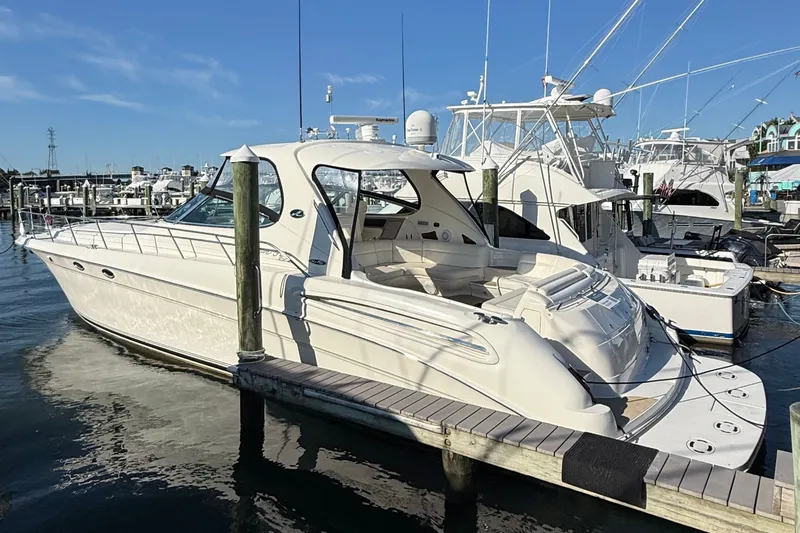 Slide: The Image of A 2003 Sea Ray 550 Sundancer docked. It features a sleek, white design. - 28