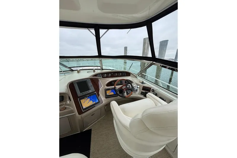 Slide: The Image of Helm of 2003 Sea Ray 550 Sundancer with navigation screens and steering wheel. - 6