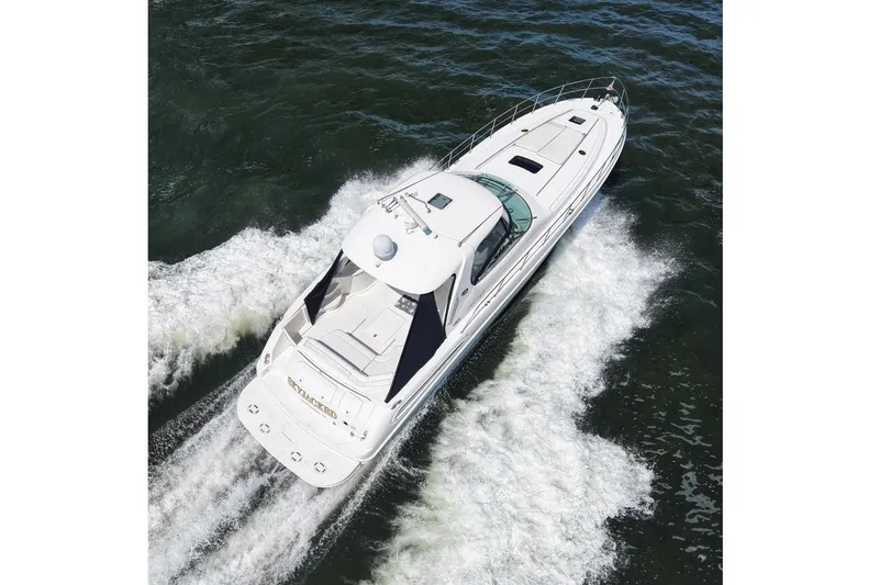Slide: The Image of 2003 Sea Ray 550 Sundancer yacht cruising on open water, aerial view. - 2