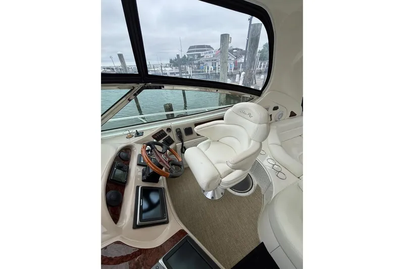 Slide: The Image of 2003 Sea Ray 550 Sundancer helm with leather captain's chair and modern navigation controls. - 8