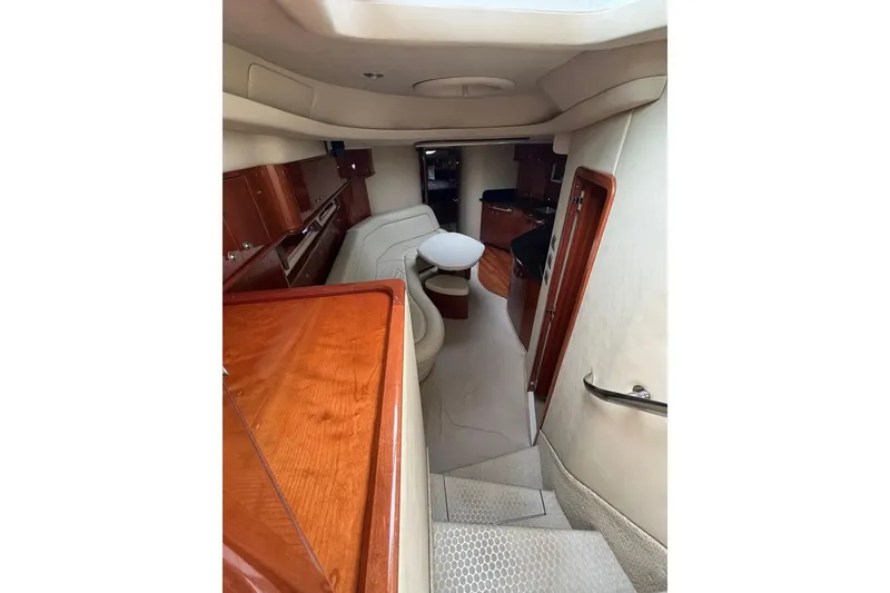 Slide: The Image of Interior of 2003 Sea Ray 550 Sundancer yacht with elegant wood finishes and seating area. - 13