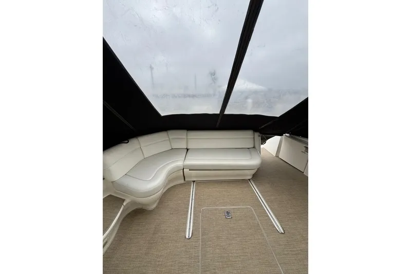 Slide: The Image of Interior of 2003 Sea Ray 550 Sundancer with white leather seating and carpeted floor. - 11