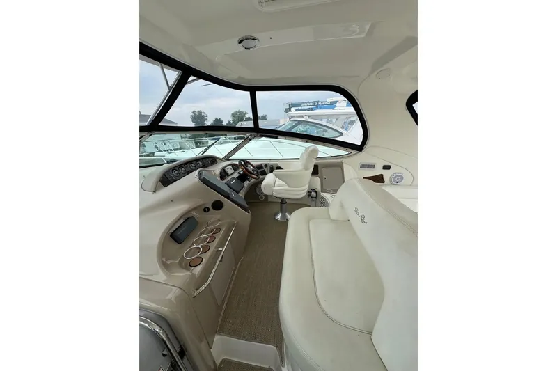 Slide: The Image of Interior view of 2003 Sea Ray 550 Sundancer yacht cockpit with helm and seating. - 5