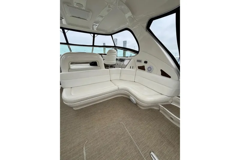 Slide: The Image of Luxurious interior of 2003 Sea Ray 550 Sundancer yacht with white seating and panoramic windows. - 10