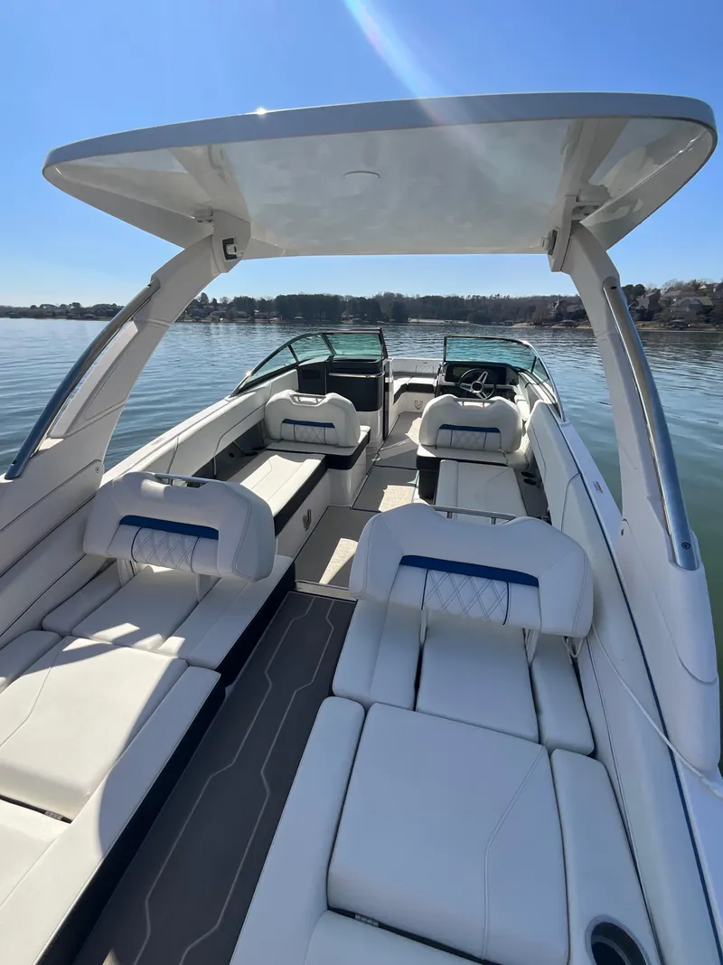 Slide: The Image of 2023 Regal LS6 boat with spacious seating and sleek design on a sunny day. - 18