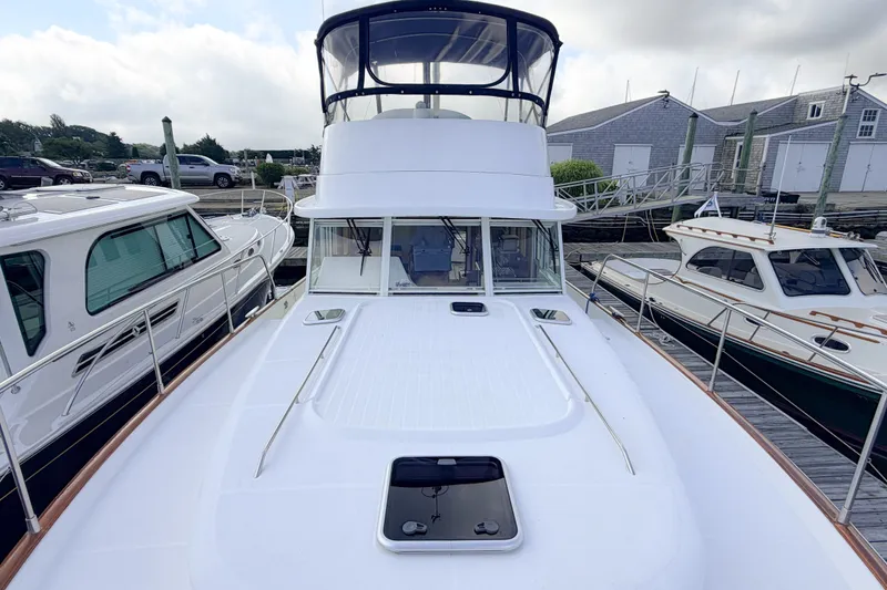 Slide: The Image of 2006 Beneteau Swift Trawler 42 docked, showcasing spacious deck and sleek design. - 31