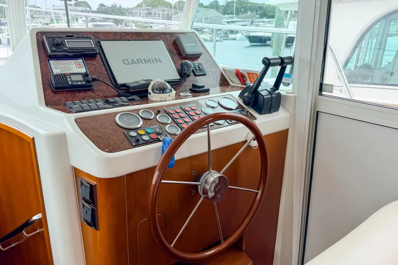 Slide: The Image of Helm of 2006 Beneteau Swift Trawler 42 with Garmin navigation system and wooden steering wheel. - 11