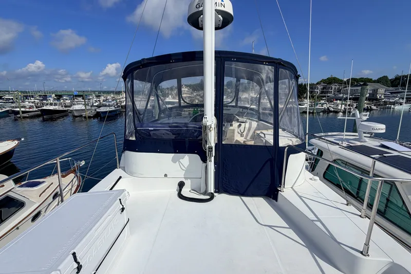 Slide: The Image of 2006 Beneteau Swift Trawler 42 docked at marina under clear blue sky. - 21