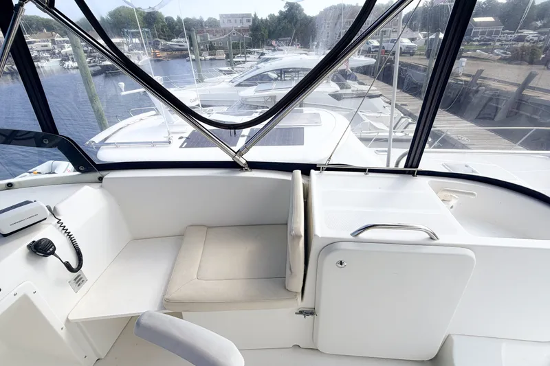 Slide: The Image of 2006 Beneteau Swift Trawler 42 helm station with marina view. - 25