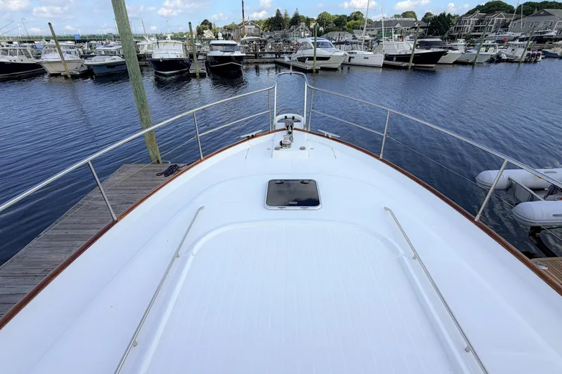 Slide: The Image of Bow view of a 2006 Beneteau Swift Trawler 42 docked at a marina. - 32