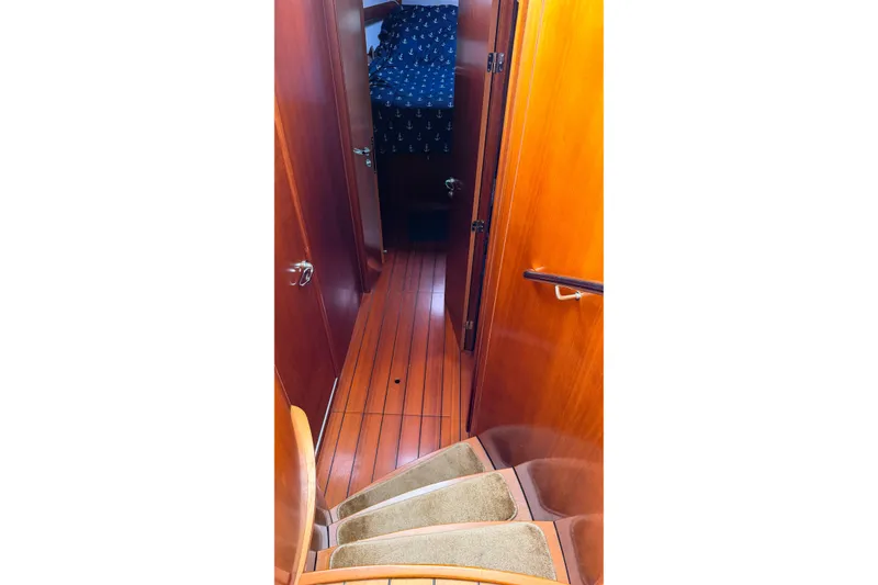Slide: The Image of Interior view of 2006 Beneteau Swift Trawler 42 with wooden flooring and stairs. - 12