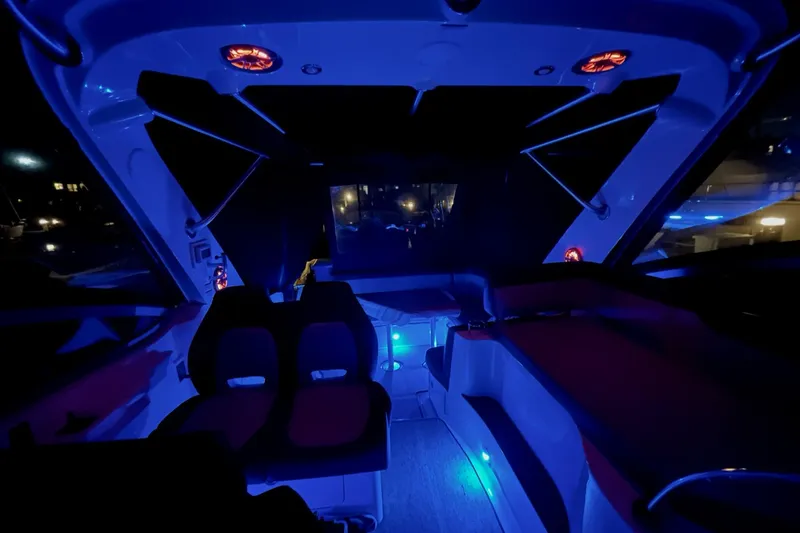 Slide: The Image of Interior of 2015 Sea Ray Sundancer 350 yacht with ambient blue lighting at night. - 32