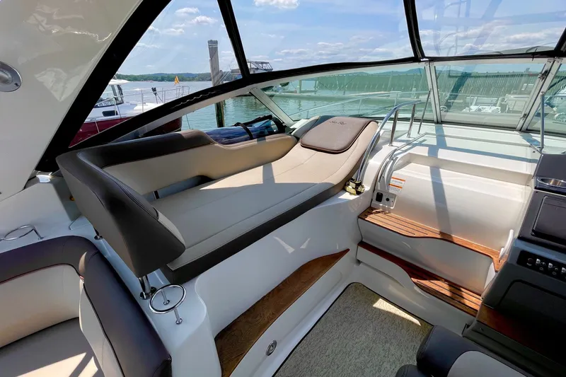 Slide: The Image of Luxurious interior of 2015 Sea Ray Sundancer 350 yacht with plush seating and scenic marina view. - 15