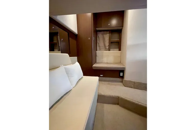 Slide: The Image of Interior of 2015 Sea Ray Sundancer 350 yacht with beige seating and wooden cabinetry. - 25