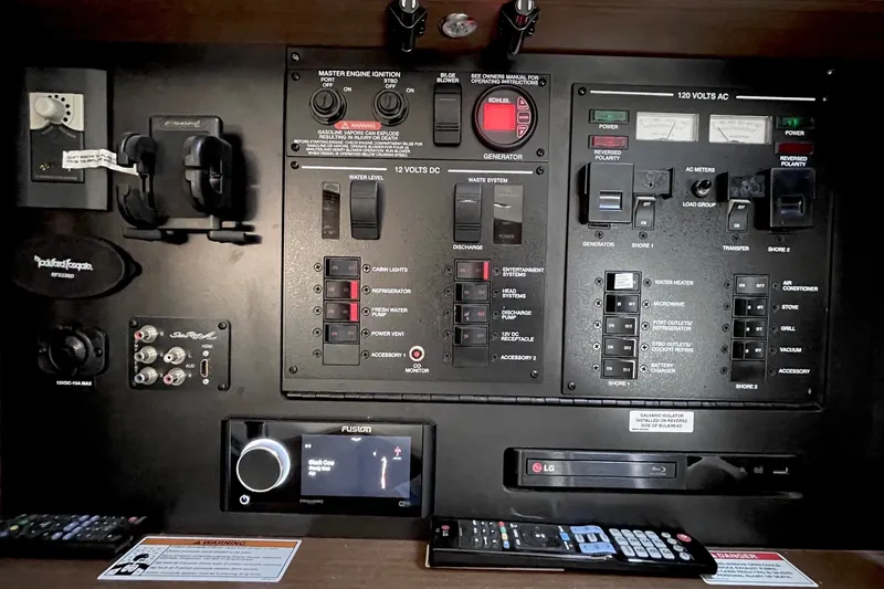 Slide: The Image of Control panel of a 2015 Sea Ray Sundancer 350 yacht with various switches and displays. - 31