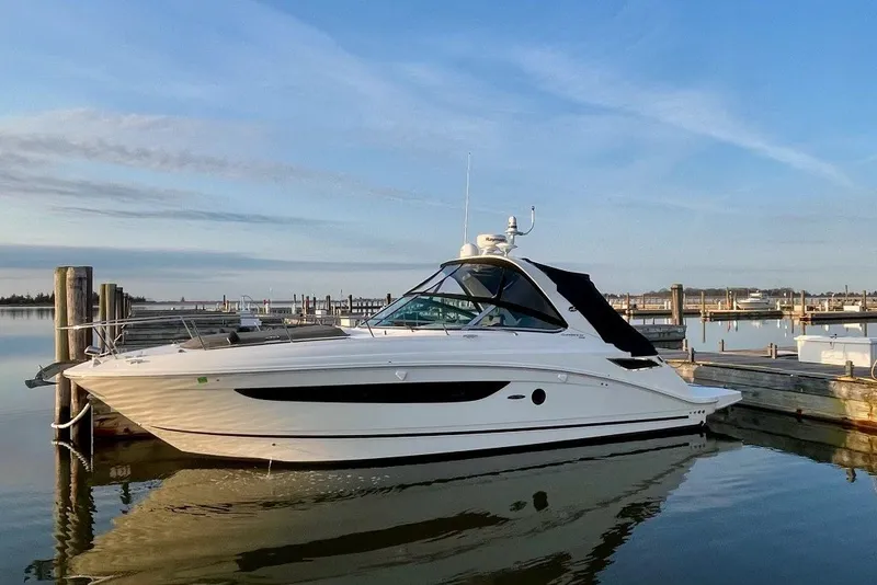 The Image of 2015 Sea Ray Sundancer 350 yacht docked at marina under clear blue sky. - 0