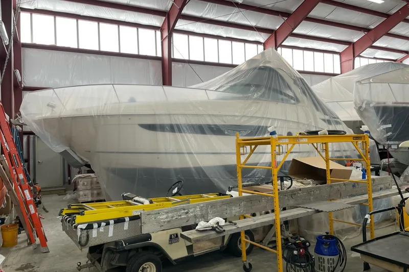 Slide: The Image of 2015 Sea Ray Sundancer 350 yacht covered in plastic, stored indoors for maintenance. - 33