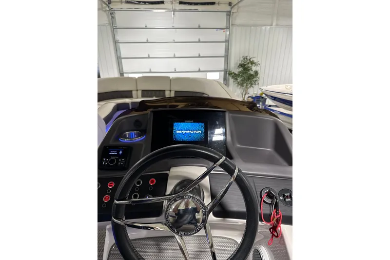 Slide: The Image of 2021 Bennington Q 25 QSBA boat dashboard with steering wheel and digital display. - 11